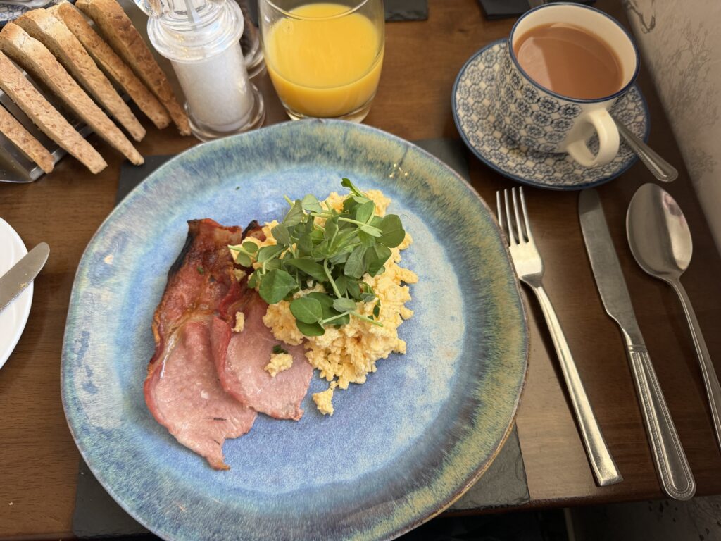 Hearty Scottish breakfast spread at Inveroran Hotel with eggs, bacon, and fresh bread