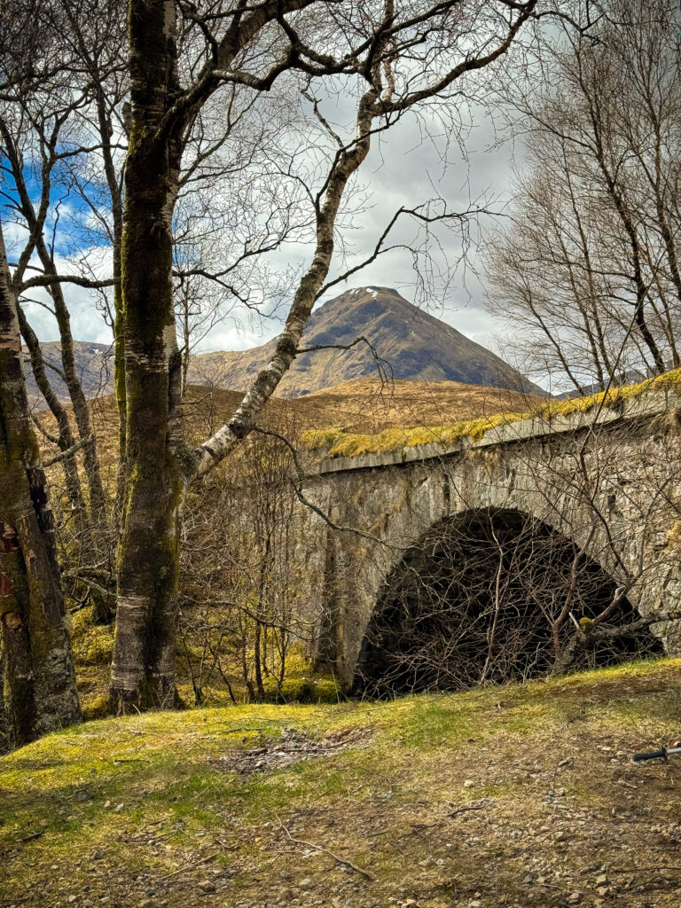 Historic stone Rannoch Moor Bridge crossing river on West Highland Way